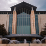 An image of Fairview Town Hall on the west-facing side of the building, with a fountain in the foreground