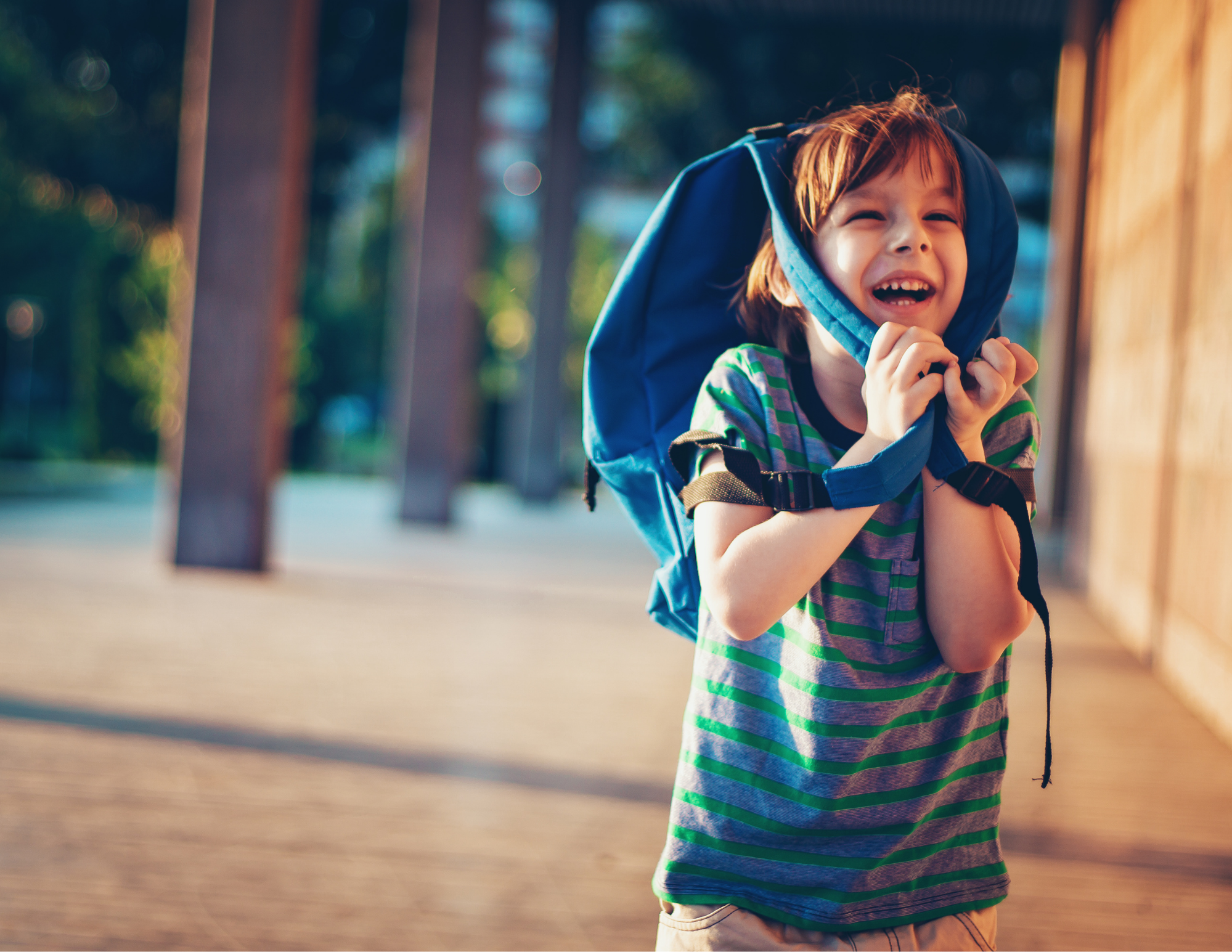 Image of a happy child carrying a backpack